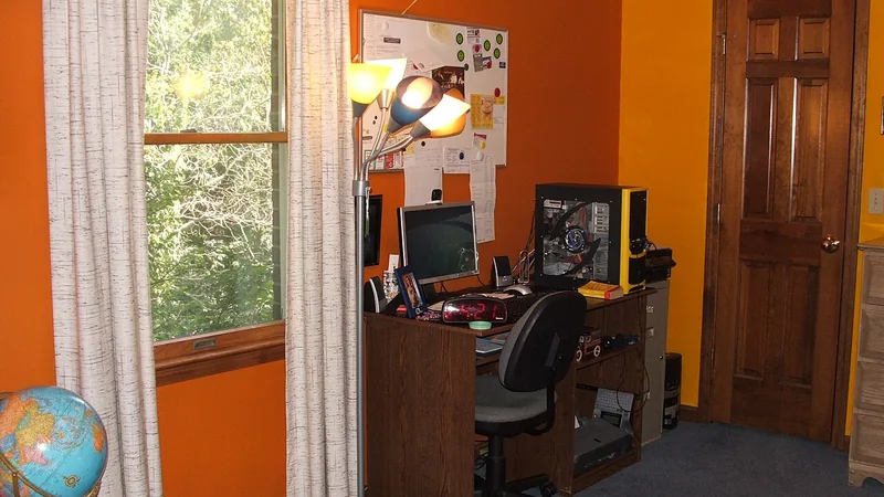 Home office workspace with a computer and desk lamp