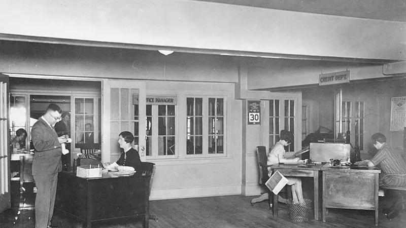 Historic monochrome photograph of a bank office interior